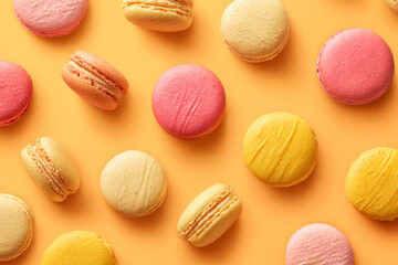 Obraz premium Colorful Macarons on Bright Orange Background for Sweet Treat Lovers