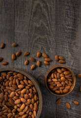 Almonds in Wooden Bowls on a Rustic Wood Background