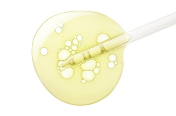 Liquid yellow gel or serum with pipette dropper on white isolated background