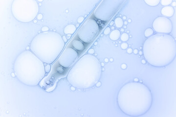 Pipette with liquid serum or lab medicaments blue on white background isolated