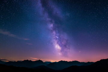 Naklejka premium Milky way night sky: majestic milky way over distant mountains
