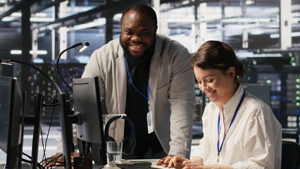 Joyous data center team leader giving high five to worker after successful infrastructure upgrade....