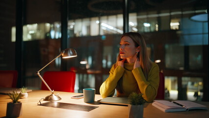 Tired businesswoman massaging neck feeling unmotivated to overtime job. 