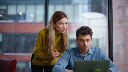 Frustrated coworkers reacting failure emotionally looking laptop screen closeup.