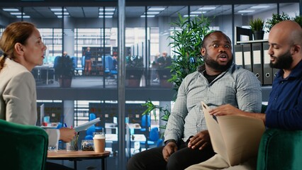 Multiethnic professionals in a heated argument during corporate negotiation, addressing leadership...