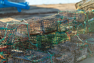 Collection of crab traps neatly stacked on a dock, prepared for an early morning crabbing...