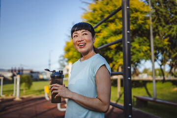 Mature japanese woman take a brake resting with supplement shaker