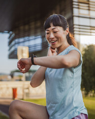 japanese woman exercise on an stationary bike in outdoor gym