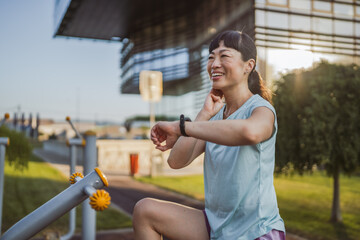 japanese woman exercise on an stationary bike in outdoor gym