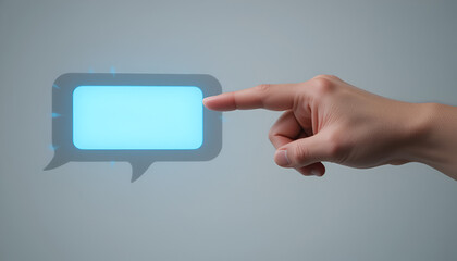 Hand touches a bright blue speech bubble suggesting communication, contact, message, online connection, and futuristic interaction on a gray background.