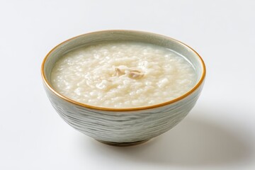 Classic chicken rice porridge in a bowl photographed against a white backdrop