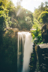 Golden Mist Over Jungle Waterfall at Sunrise