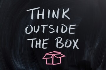 Think Outside the Box Inspiration Written on Blackboard