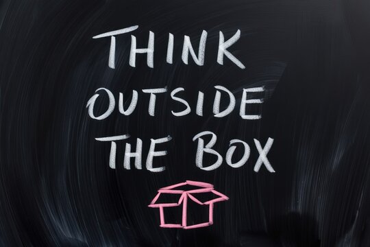 Think Outside the Box Inspiration Written on Blackboard