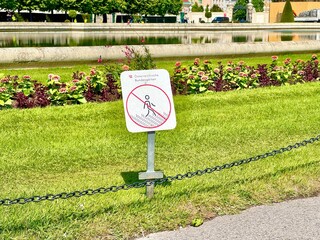 No walking on grass sign near garden