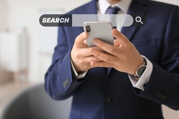 Young businessman with mobile phone using web search engine, closeup