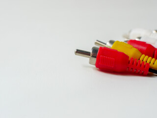 RCA cable with red, yellow, and white connectors, used for audio and video connections, isolated on a white background.