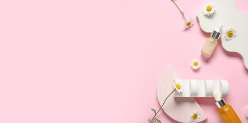 Bottles of cosmetic oil and chamomile flowers on pink background with space for text