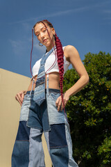 Woman with braids and eye-catching denim outfit