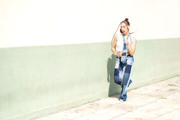 Stylish woman showcasing unique patchwork denim jeans in motion