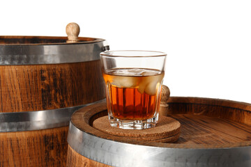 Wooden barrels and glass of cold rum on white background