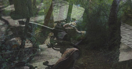 Wheelchair resting on wooden deck beside paved stone pathway in private garden, dappled sunlight