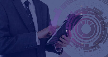 Presenting suited business executive holding tablet in studio with data visualization, copy space