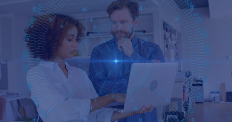 Two professionals analyzing data on laptop in modern office, with blue HUD overlay and shelving