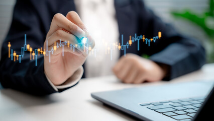 Businessman analyzing digital stock chart on virtual screen, representing stock trading, forex...