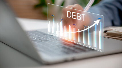 The rising debt graph on the laptop screen represents the increasing financial burden or business...