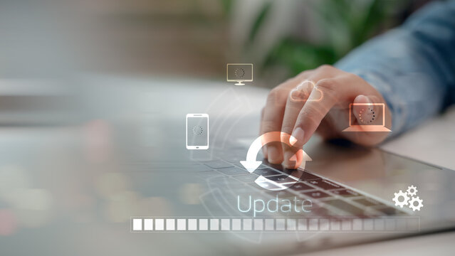 Close-up hand using laptop with system update progress bar and cloud sync icons. Concept of software upgrade, digital transformation, and technology maintenance in modern connected devices. - Powered by Adobe