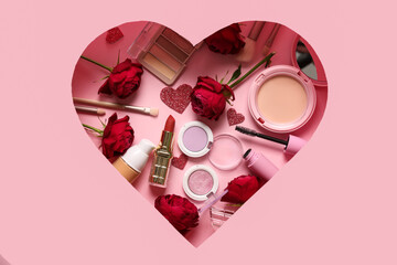 Cut pink paper in shape of heart with cosmetic products and red roses on color background....