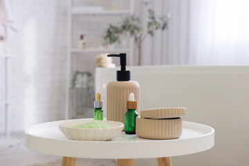 Bath accessories with sea salt on table in room, closeup