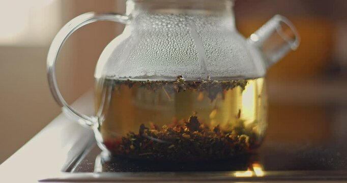 tea is brewed in a glass teapot, evaporation drops on the walls of the teapot