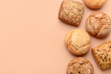 Different delicious buns on beige background