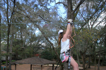 Girl Ziplining in Outdoor Adventure Park