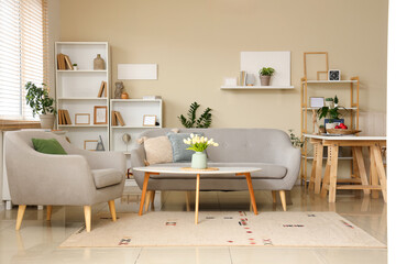 Interior of stylish living room with sofa, coffee table and shelving unit