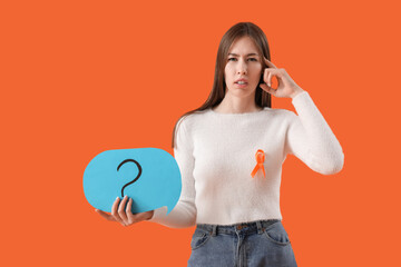 Beautiful young thoughtful woman with ribbon and speech bubble on orange background. Multiple...