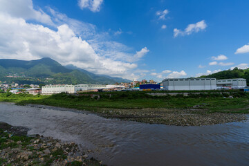 The Bagmati River near Chovar Dry Port presents a stunning mountain view with monsoon clouds, offering a wide landscape in Nepal.