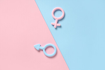 Male and female gender symbols made of plasticine on color background