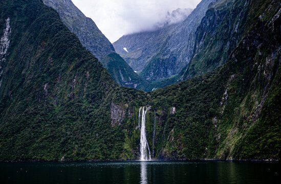 Milford sound fiordland new zealand national park beautiful landscape nature fiords low cloud fog dramatic sky iconic - Powered by Adobe