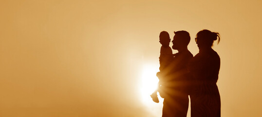 Obraz na płótnie Canvas people in the park. happy family walking silhouette at sunset. mom dad and kid son walk holding on hands. happy family childhood concept. parents and children sun go back on sunset sky background