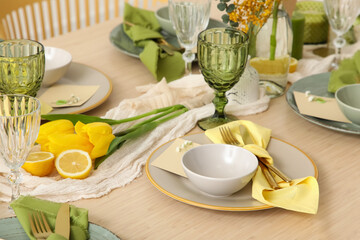 Table setting with spring flowers in room, closeup