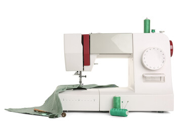 Sewing machine with cloth and thread spools on white background