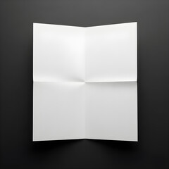 A pristine white paper, neatly folded, rests on a stark black background, ready for content.