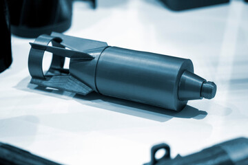 Bomb. Bomb model for drone. Model of bomb printed on 3D printer from melted plastic. Body of bomb with tail created on 3D printer. Prototype of ammunition printed on 3D printer. Innovation 3d printing