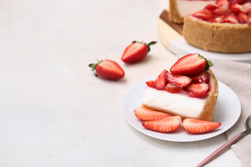 Plate with piece of sweet strawberry tart on white background
