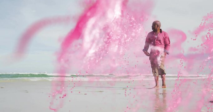 Tech-demo pink CGI swirl sweeping, senior man walking barefoot shore, pausing and observing surf