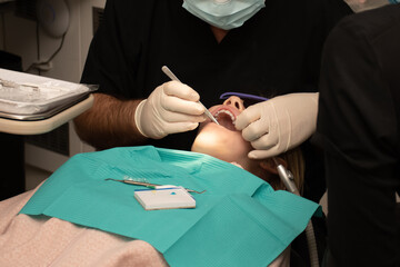 Dental treatment. Orthodontic treatment. Toothache. Girl with open mouth at the dental chair.
