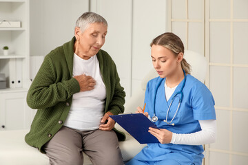 Fototapeta premium Senior woman visiting nurse in clinic